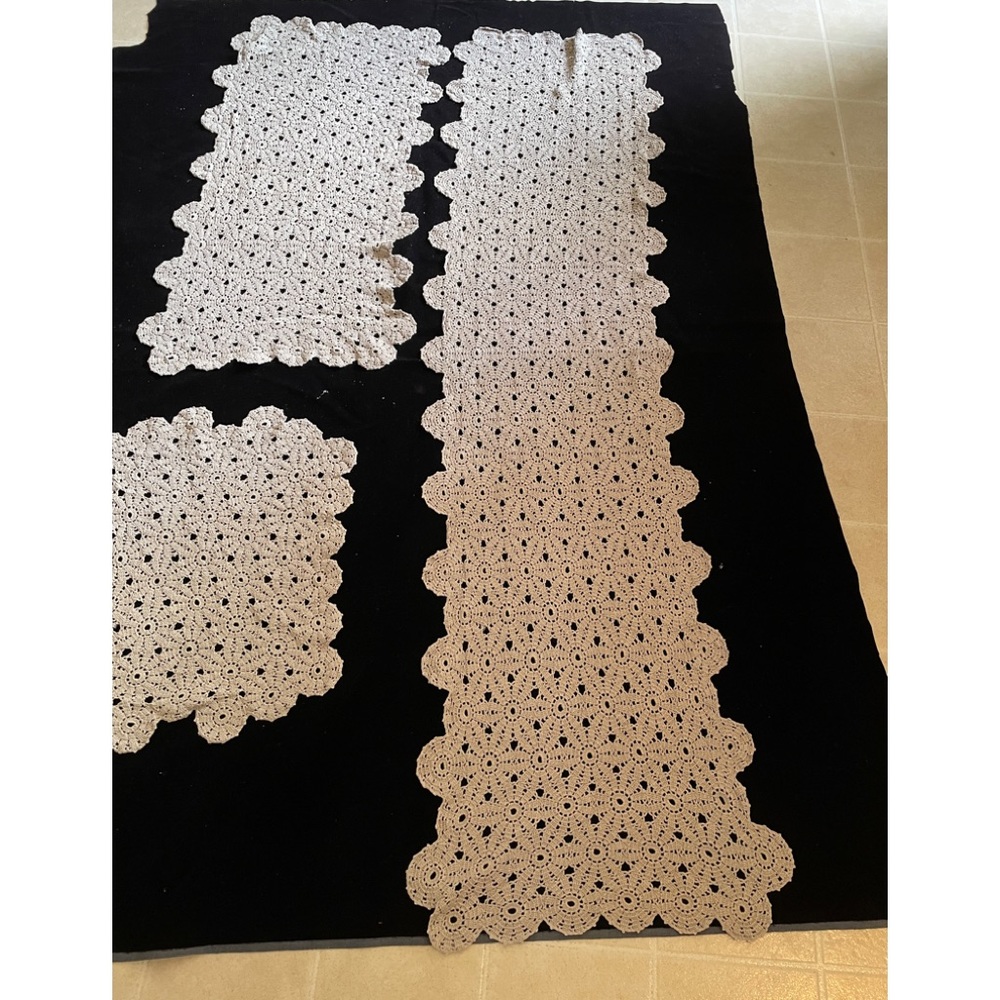 Set of three crocheted runners and doily.